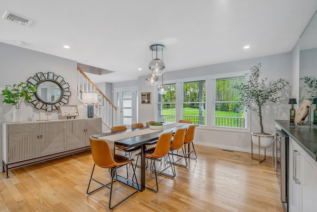 56 N Woods Rd, Baiting Hollow, NY 11933 - dining space featuring baseboards, light wood-style floors, stairs, healthy amount of natural light, and recessed lighting