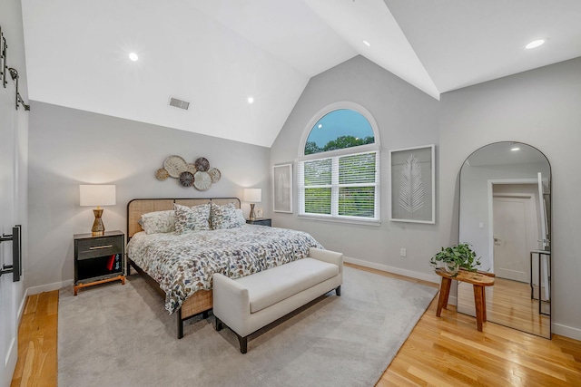 56 N Woods Rd, Baiting Hollow, NY 11933 - bedroom with high vaulted ceiling, light wood-style floors, baseboards, recessed lighting, and arched walkways