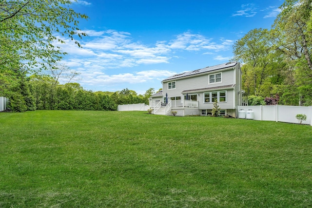 56 N Woods Rd, Baiting Hollow, NY 11933 - back of property with a wooden deck and solar panels