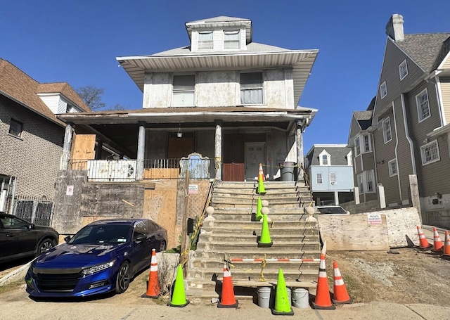 traditional style home featuring a porch and stairway