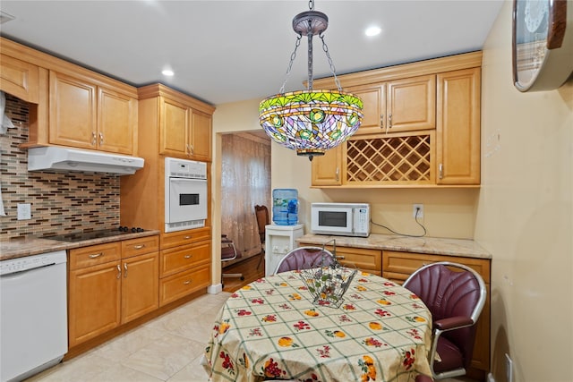 kitchen with pendant lighting, white appliances, under cabinet range hood, tasteful backsplash, and recessed lighting