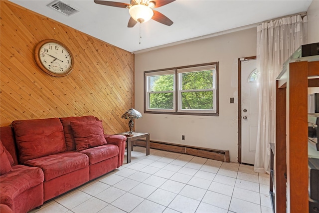 living room featuring an accent wall, wood walls, a ceiling fan, and visible vents