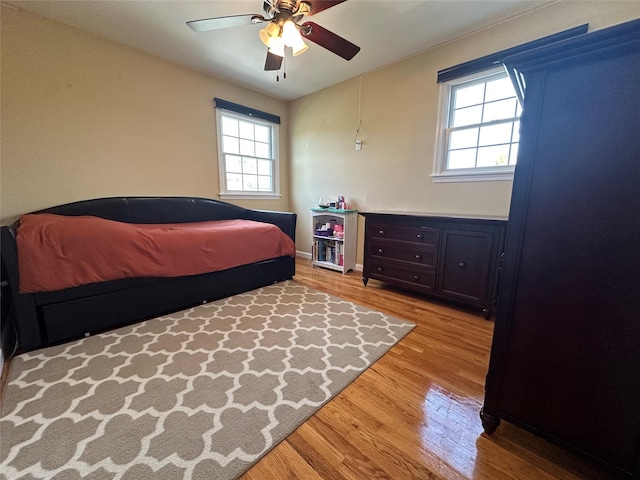 bedroom featuring a ceiling fan and wood finished floors