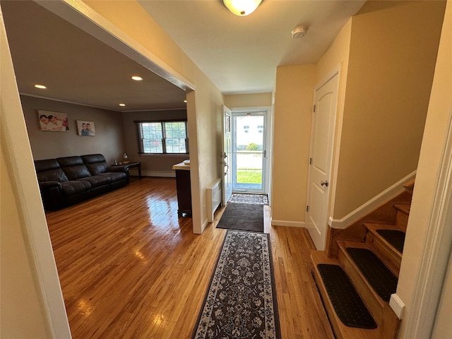 entrance foyer featuring light wood finished floors, stairway, baseboards, visible vents, and recessed lighting