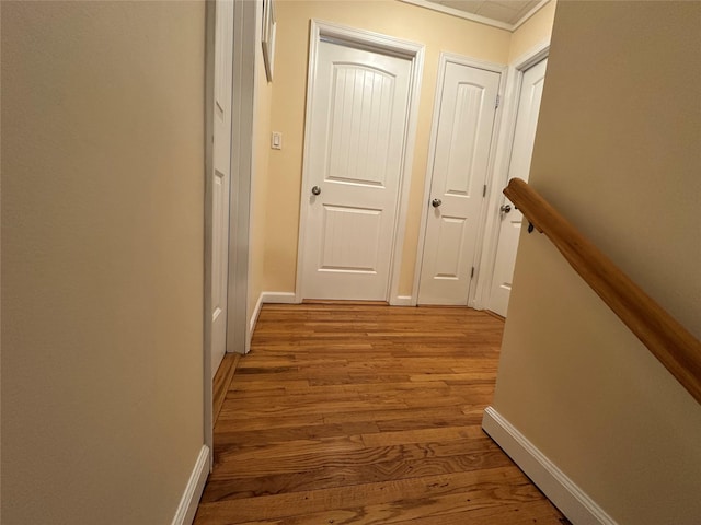 hall with baseboards and light wood-style floors