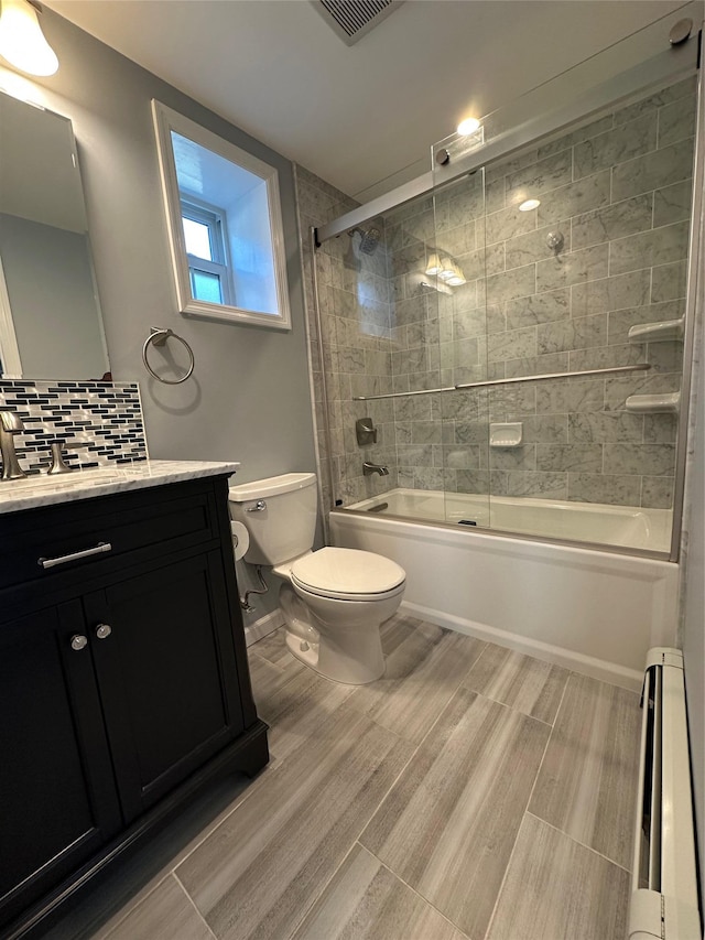 full bath featuring toilet, a baseboard heating unit, visible vents, vanity, and wood finished floors