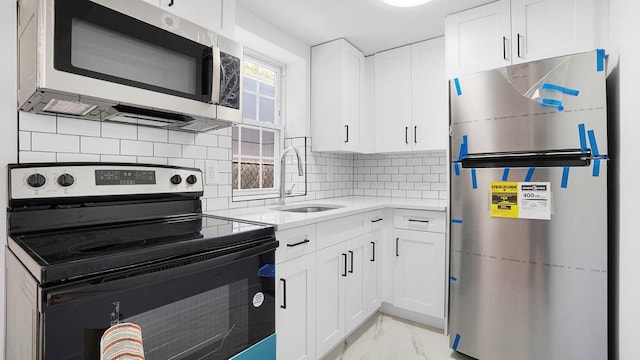 2227 Boller Ave, Bronx, NY 10475 - kitchen with appliances with stainless steel finishes, a sink, light marble finish floors, light countertops, and white cabinets