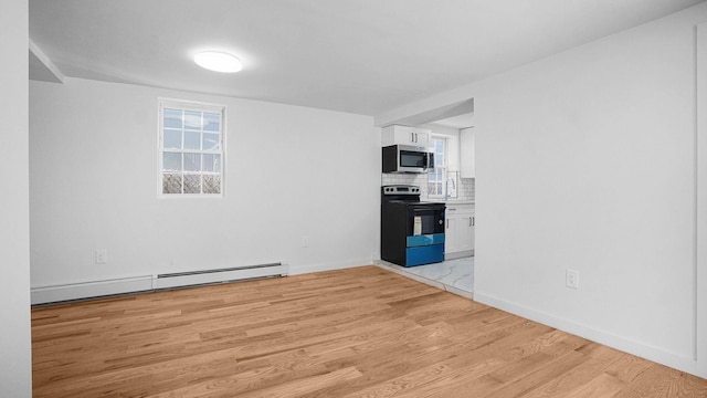2227 Boller Ave, Bronx, NY 10475 - spare room with a baseboard heating unit, light wood finished floors, and baseboards