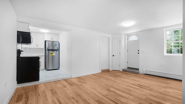 2227 Boller Ave, Bronx, NY 10475 - entryway featuring a baseboard heating unit, light wood finished floors, and baseboards