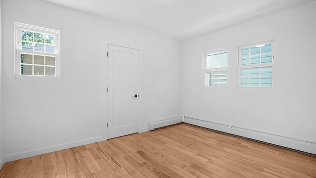 2227 Boller Ave, Bronx, NY 10475 - empty room featuring light wood finished floors, baseboards, and a baseboard heating unit