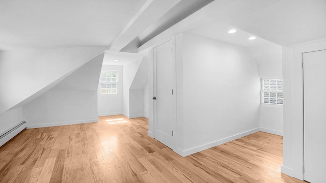 2227 Boller Ave, Bronx, NY 10475 - additional living space with light wood-style flooring, a baseboard heating unit, baseboards, vaulted ceiling, and recessed lighting