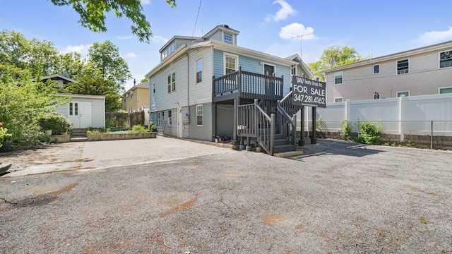2227 Boller Ave, Bronx, NY 10475 - back of property featuring fence, an outdoor structure, a wooden deck, a storage unit, and stairs
