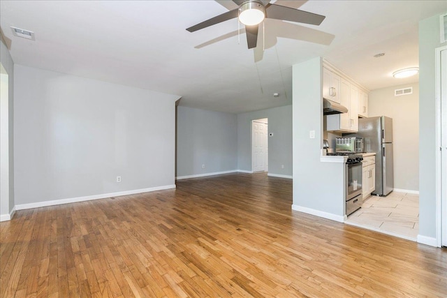 152 Artist Lake Dr Unit 152, Middle Island, NY 11953 - unfurnished living room featuring light wood-style flooring, a ceiling fan, and baseboards