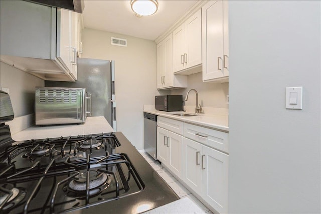152 Artist Lake Dr Unit 152, Middle Island, NY 11953 - kitchen featuring a sink, light countertops, dishwasher, white cabinetry, and range