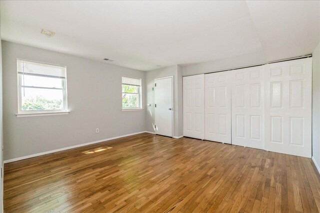 152 Artist Lake Dr Unit 152, Middle Island, NY 11953 - unfurnished bedroom with wood finished floors, baseboards, and a closet