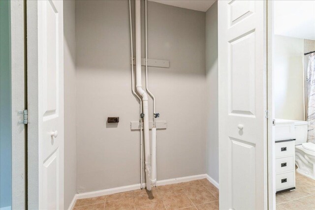 152 Artist Lake Dr Unit 152, Middle Island, NY 11953 - laundry room featuring baseboards and light tile patterned floors