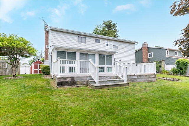 402 Spangle Dr, North Babylon, NY 11703 - rear view of house featuring a storage shed, a chimney, a deck, and a sunroom