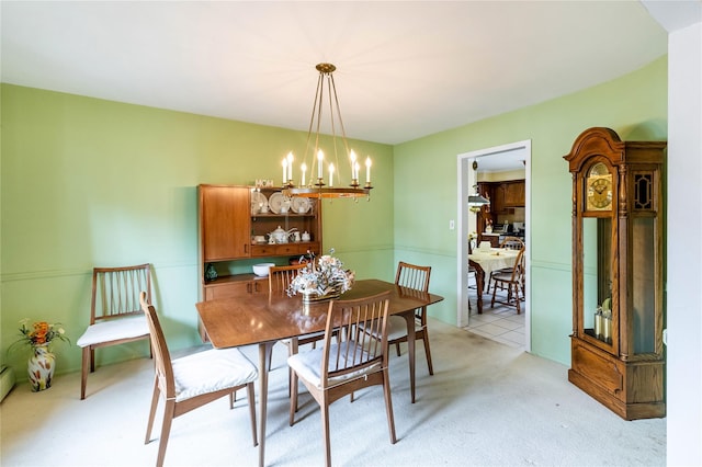 402 Spangle Dr, North Babylon, NY 11703 - dining space with a chandelier, light colored carpet, and a baseboard radiator