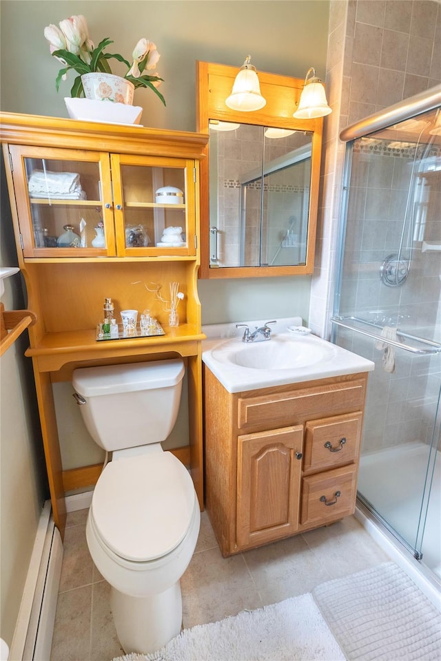 402 Spangle Dr, North Babylon, NY 11703 - bathroom featuring baseboard heating, vanity, tile patterned flooring, and a shower stall