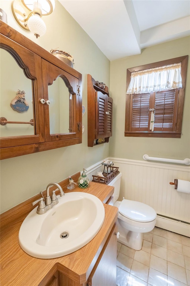 402 Spangle Dr, North Babylon, NY 11703 - bathroom featuring a baseboard radiator, wainscoting, tile patterned floors, and vanity