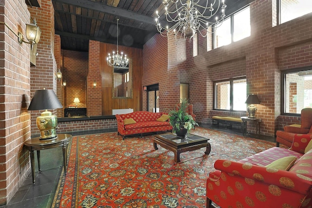 lobby with a high ceiling, beamed ceiling, and brick wall