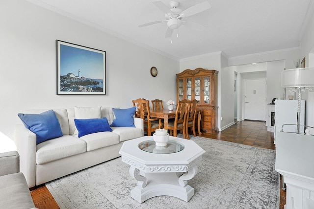 living room featuring crown molding and a ceiling fan