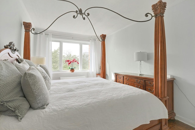 bedroom featuring ornamental molding and baseboards