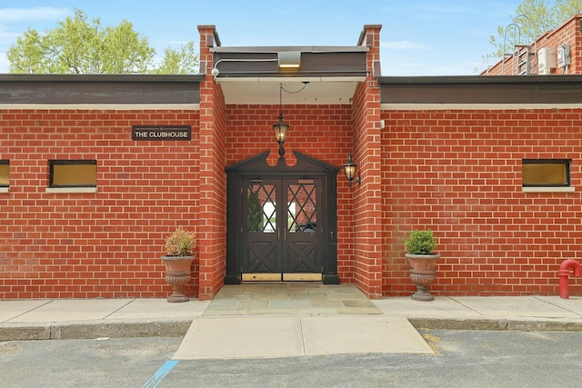 doorway to property with brick siding