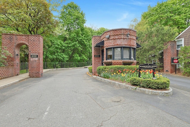 view of asphalt road featuring curbs