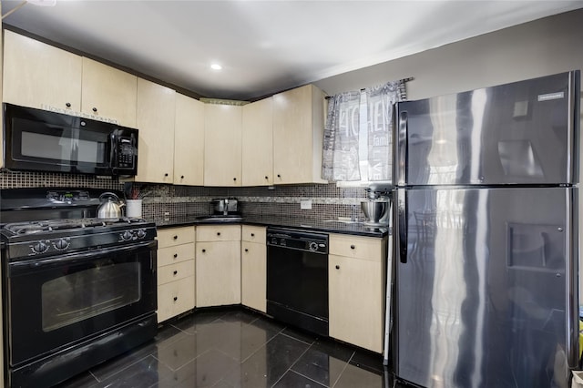 kitchen with black appliances, dark countertops, cream cabinetry, dark tile patterned flooring, and decorative backsplash