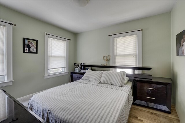 bedroom featuring wood finished floors and baseboards