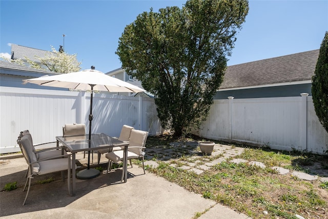 view of patio with outdoor dining space and a fenced backyard