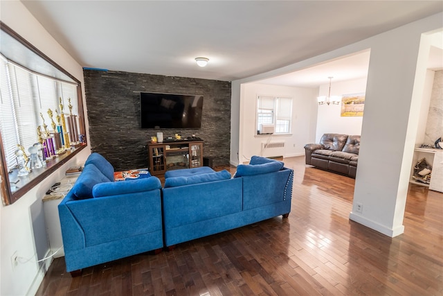 living room featuring baseboards, radiator, a notable chandelier, and dark wood-style floors