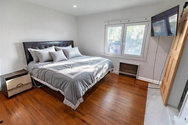bedroom featuring baseboards, recessed lighting, and wood finished floors