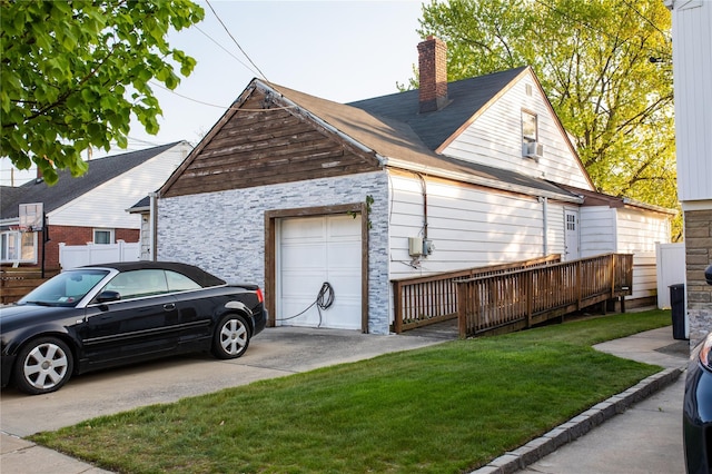 view of home's exterior featuring stone siding, a yard, concrete driveway, a garage, and a chimney