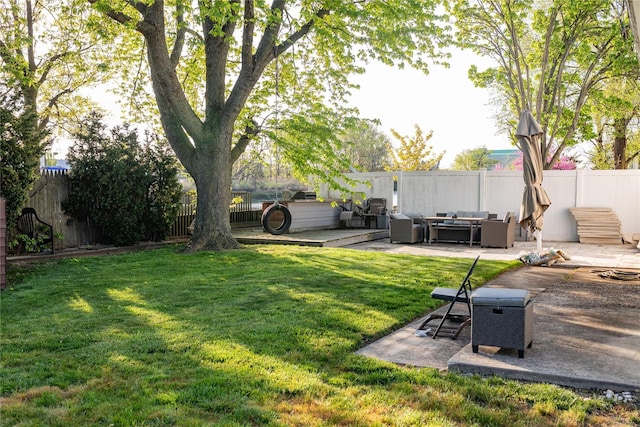 view of yard featuring an outdoor living space, a patio area, and a fenced backyard