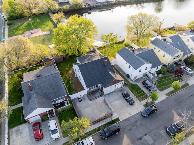 birds eye view of property with a water view and a residential view