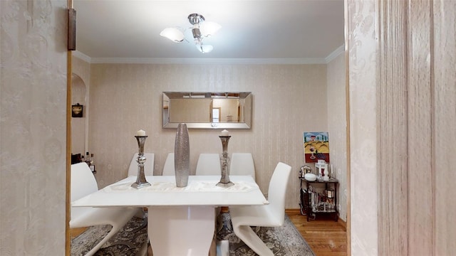 dining area featuring crown molding and wood finished floors