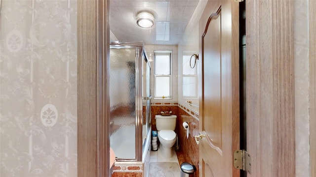 bathroom featuring toilet and a shower stall