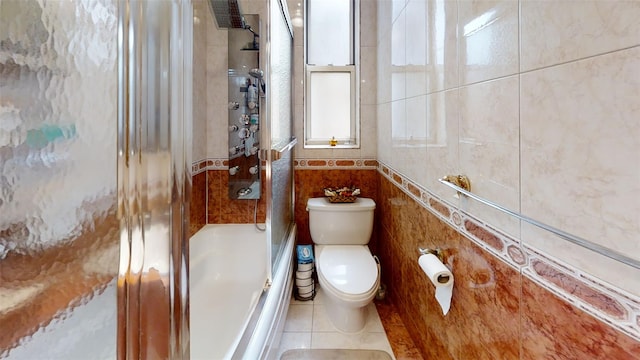 bathroom featuring toilet, tile walls, tile patterned floors, and enclosed tub / shower combo