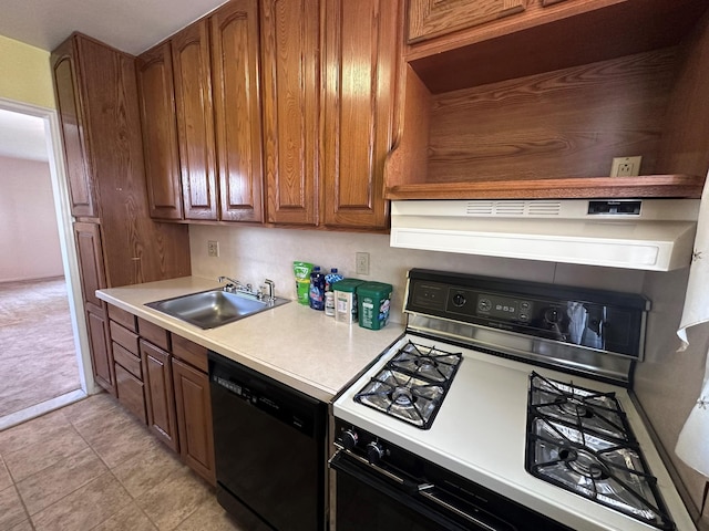 kitchen with gas range gas stove, black dishwasher, a sink, and light countertops