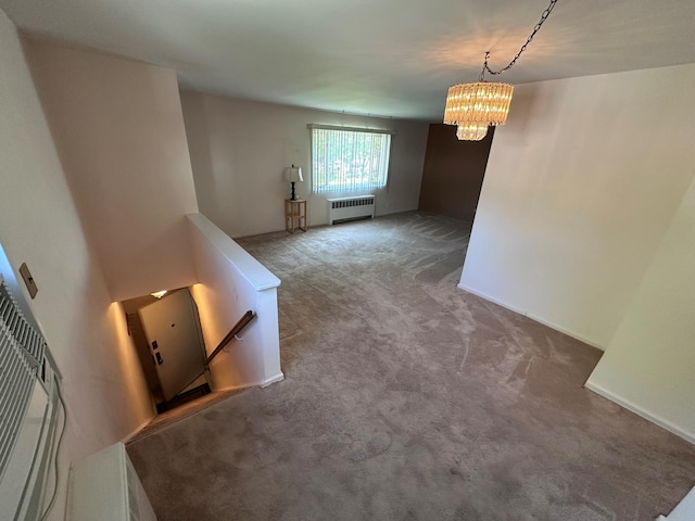 interior space featuring radiator, carpet floors, and a chandelier