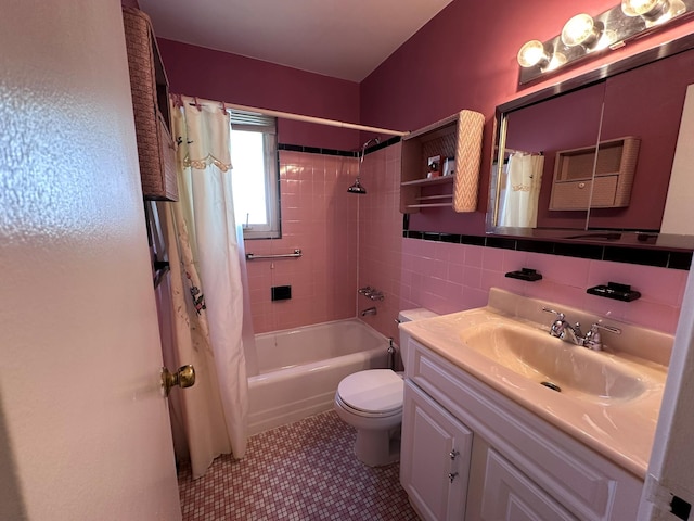 full bathroom with tile walls, vanity, toilet, and shower / bathtub combination with curtain