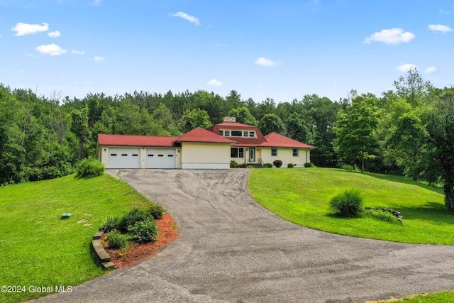346 Gifford Hollow Rd, Call Listing Agent, NY 12023 - view of front of home with an attached garage, asphalt driveway, a forest view, and a front lawn