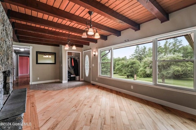 346 Gifford Hollow Rd, Call Listing Agent, NY 12023 - unfurnished living room with baseboards, hardwood / wood-style floors, beam ceiling, wooden ceiling, and a chandelier