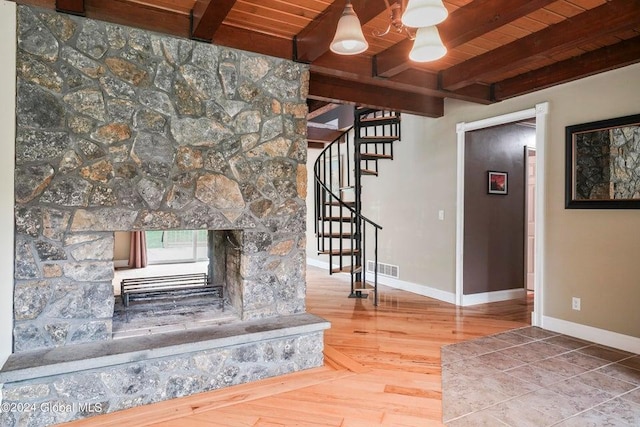346 Gifford Hollow Rd, Call Listing Agent, NY 12023 - stairs featuring wood ceiling, beamed ceiling, baseboards, wood finished floors, and a stone fireplace