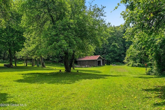 346 Gifford Hollow Rd, Call Listing Agent, NY 12023 - view of grassy yard with an outdoor structure and a forest view