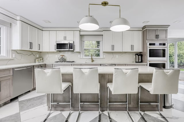 kitchen with backsplash, a wealth of natural light, and appliances with stainless steel finishes