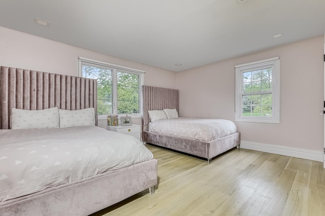 bedroom with wood finished floors and baseboards