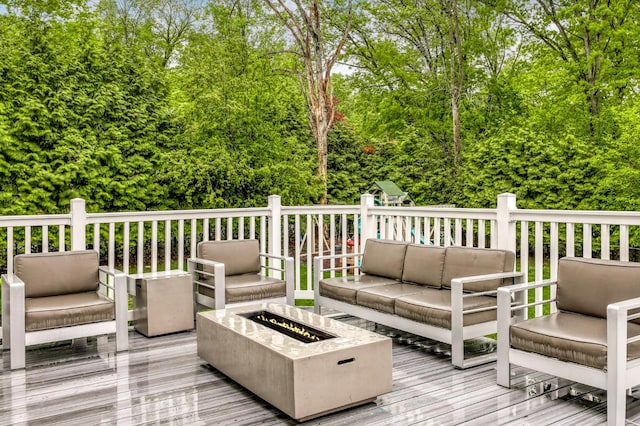 deck featuring an outdoor living space with a fire pit and a playground